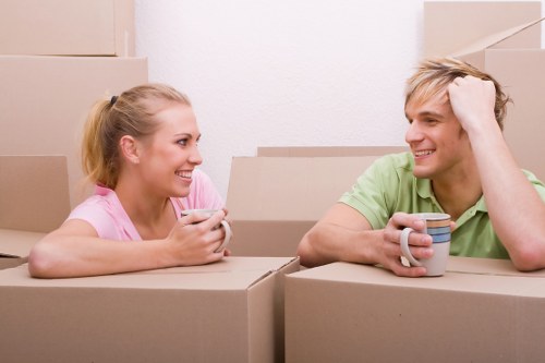 Moving crew handling furniture removals in Shepherdsbush on a busy London street