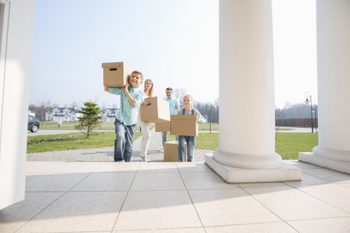 Professional movers loading furniture during an urgent Shepherdsbush relocation