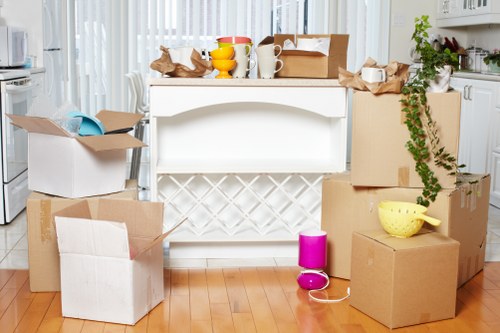 Packed moving boxes and furniture for Shepherdsbush removals