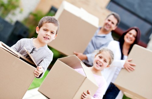 Packed boxes and furniture ready for collection by a moving van in Shepherds Bush