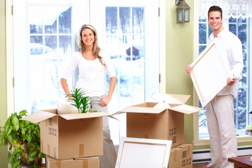 Using protective covers and straps to move furniture safely