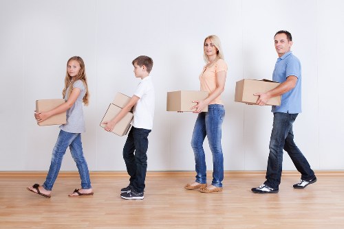 Professional movers planning furniture removals in Shepherdsbush inside a flat